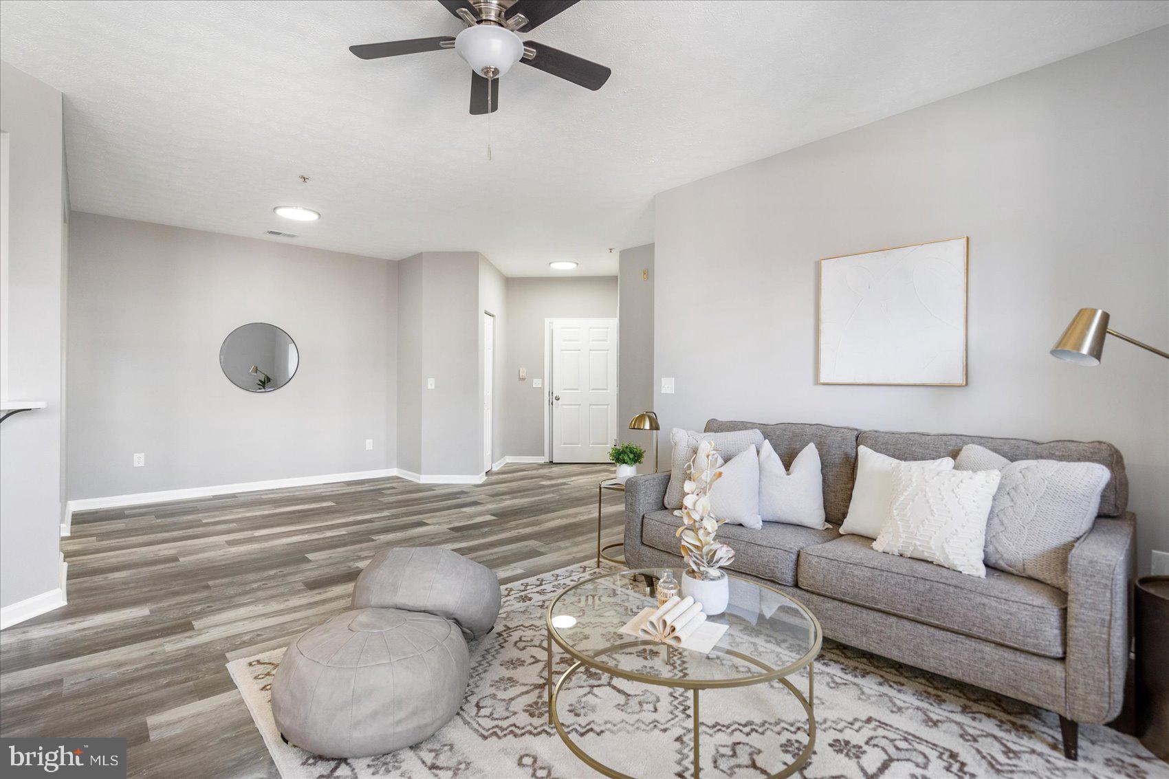 5386 Glenthorne Court, Unit 5386 Baltimore, MD 21237 - Photo 5 of 36 a living room with furniture and a large window