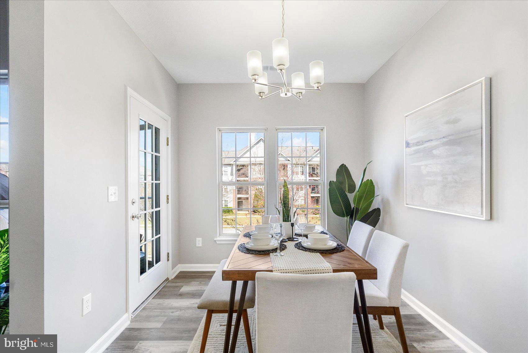 5386 Glenthorne Court, Unit 5386 Baltimore, MD 21237 - Photo 10 of 36 a view of a dining room with furniture a chandelier and wooden floor
