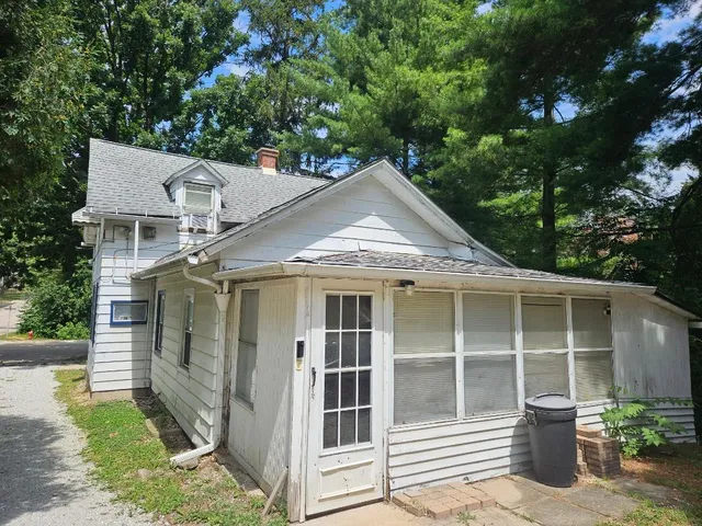 a side view of a house with a yard