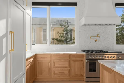 a kitchen with granite countertop a stove and a refrigerator