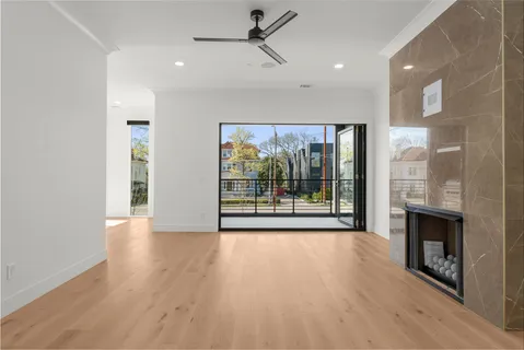 a view of an empty room with a fireplace and a window