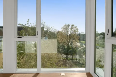 a spacious bathroom with a tub sink and mirror