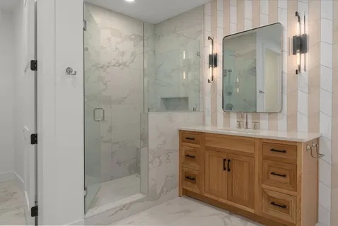 a spacious bathroom with a granite countertop sink a toilet and a mirror