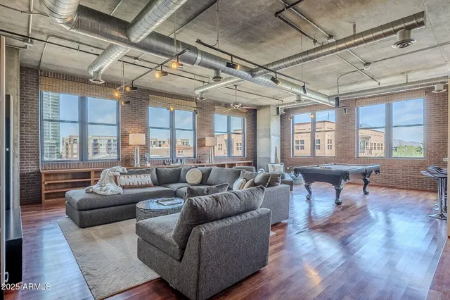 a living room with furniture a wooden floor and a chandelier