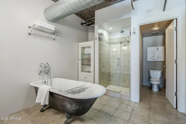 a spacious bathroom with a sink a toilet and shower