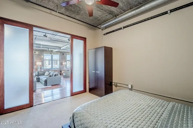 a bedroom with a bed and glass door