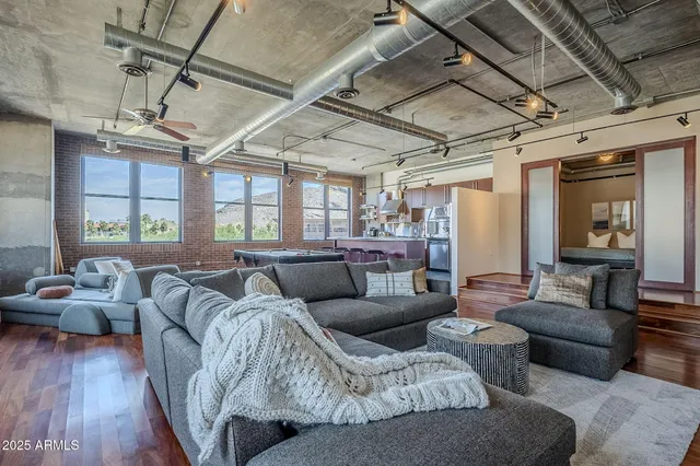 a living room with furniture and wooden floors