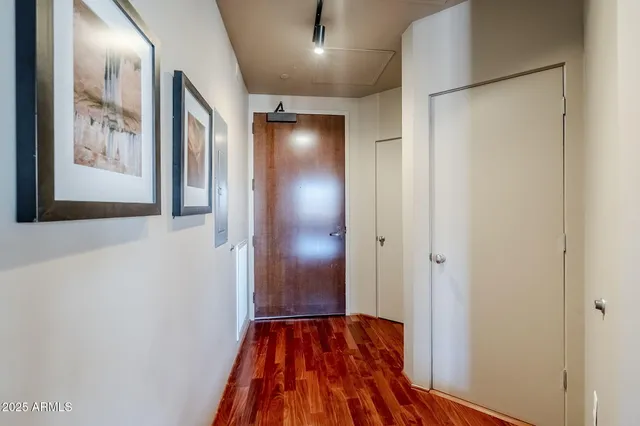 a view of a hallway with wooden floor