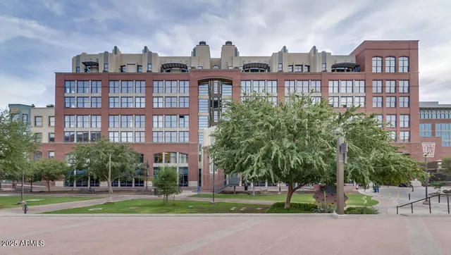 a view of a tall building next to a road