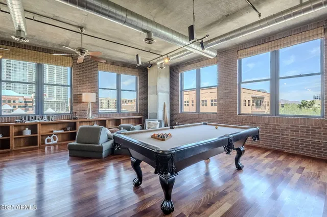 a living room with furniture a table and wooden floor
