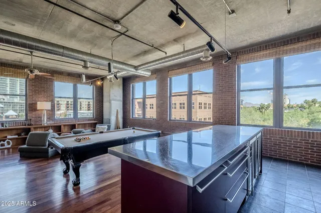 a kitchen with a table chairs and wooden floor