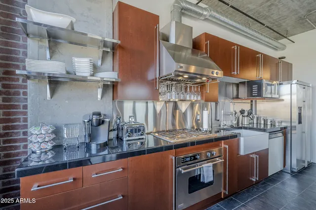 a kitchen with stainless steel appliances granite countertop a stove and a sink