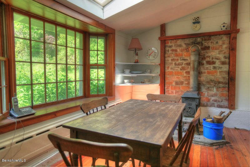 66 Fox Road Sandisfield, MA 01255 - Photo 23 of 54 a dining room with a large window and table