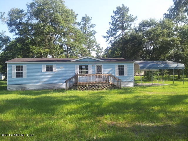 4127 Bronco Road Middleburg, FL 32068 - Photo 1 of 13 a backyard of a house with table and chairs