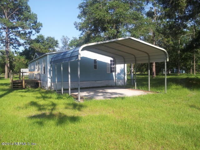 4127 Bronco Road Middleburg, FL 32068 - Photo 12 of 13 a backyard of a house with yard table and chairs