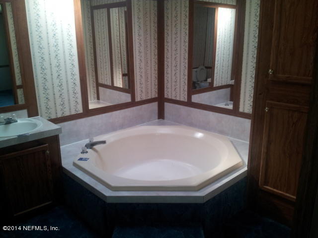 4127 Bronco Road Middleburg, FL 32068 - Photo 5 of 13 a bathroom with a sink and a mirror