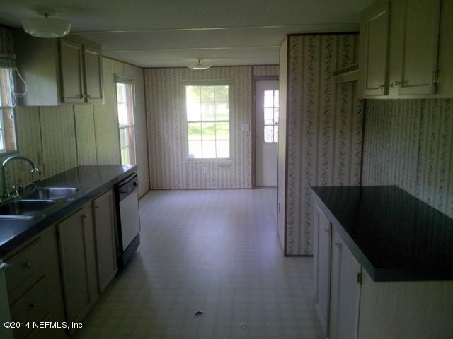 4127 Bronco Road Middleburg, FL 32068 - Photo 6 of 13 a kitchen with a sink and cabinets