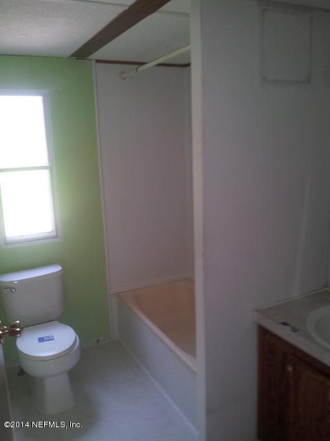 4127 Bronco Road Middleburg, FL 32068 - Photo 10 of 13 a bathroom with a toilet and a shower