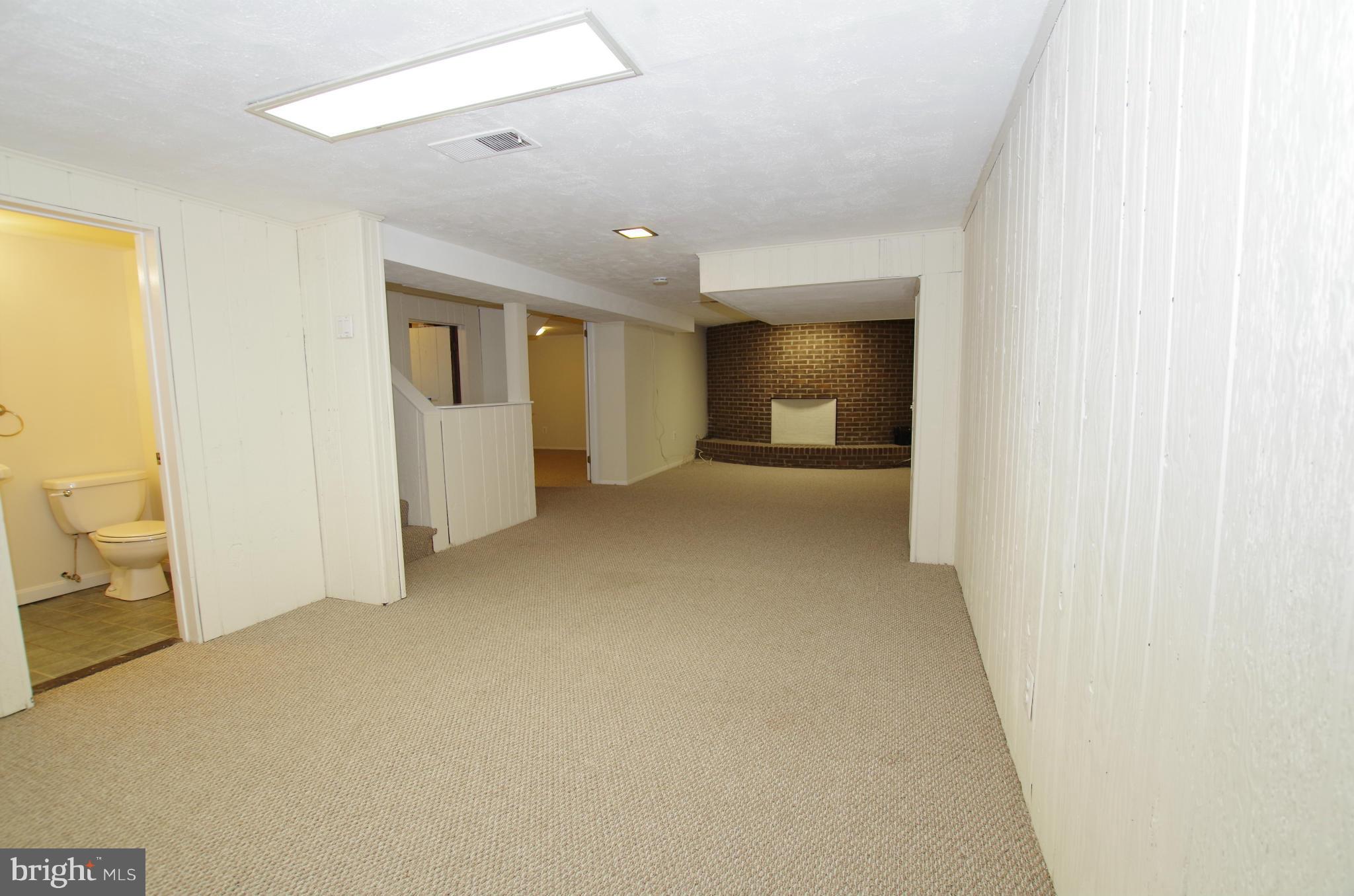12624 Epping Road Silver Spring, MD 20906 - Photo 19 of 30 Lower Level Rec Room with Brick Wall Accent