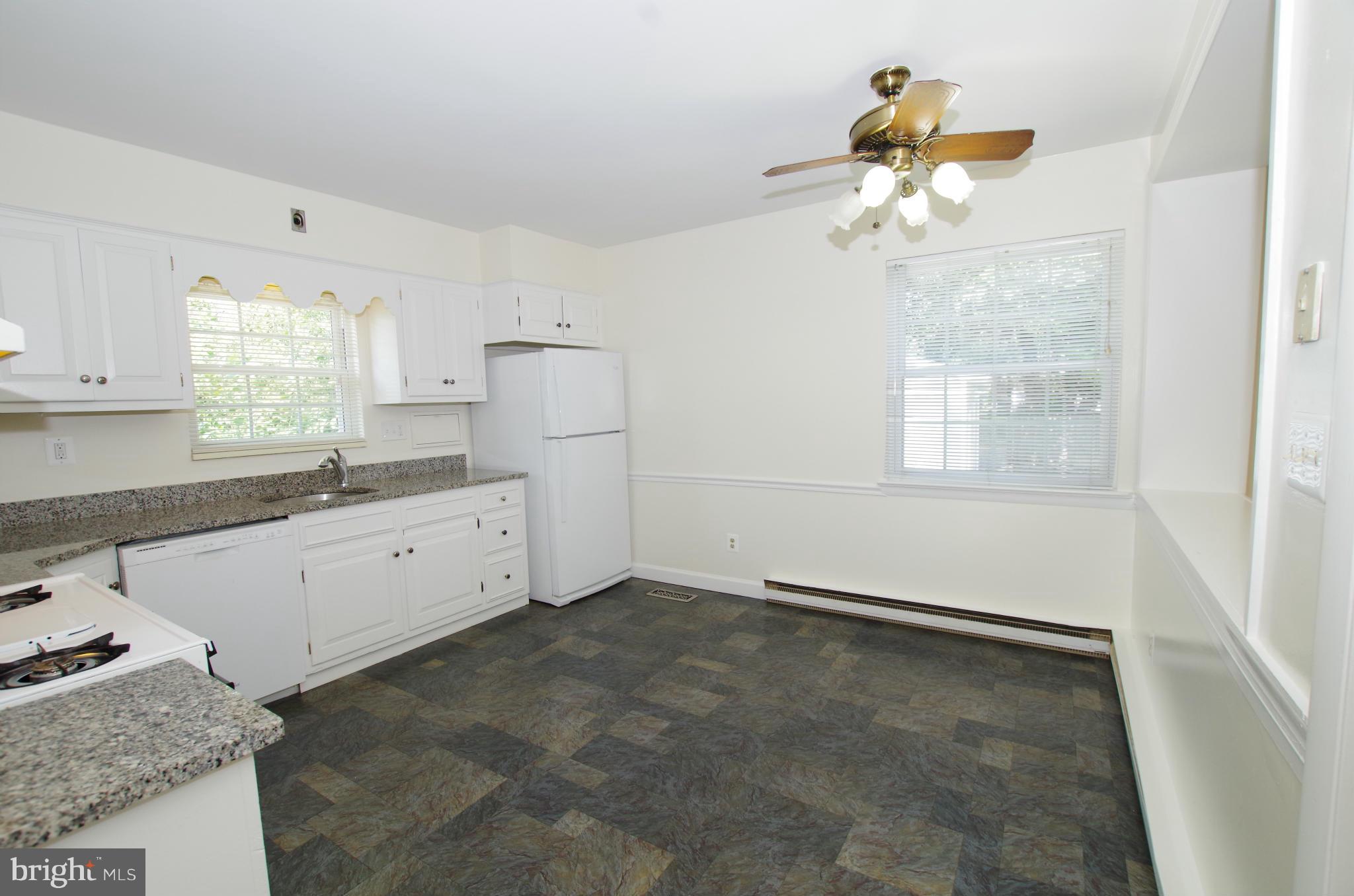 12624 Epping Road Silver Spring, MD 20906 - Photo 10 of 30 Kitchen with White Cabinets and Appliances