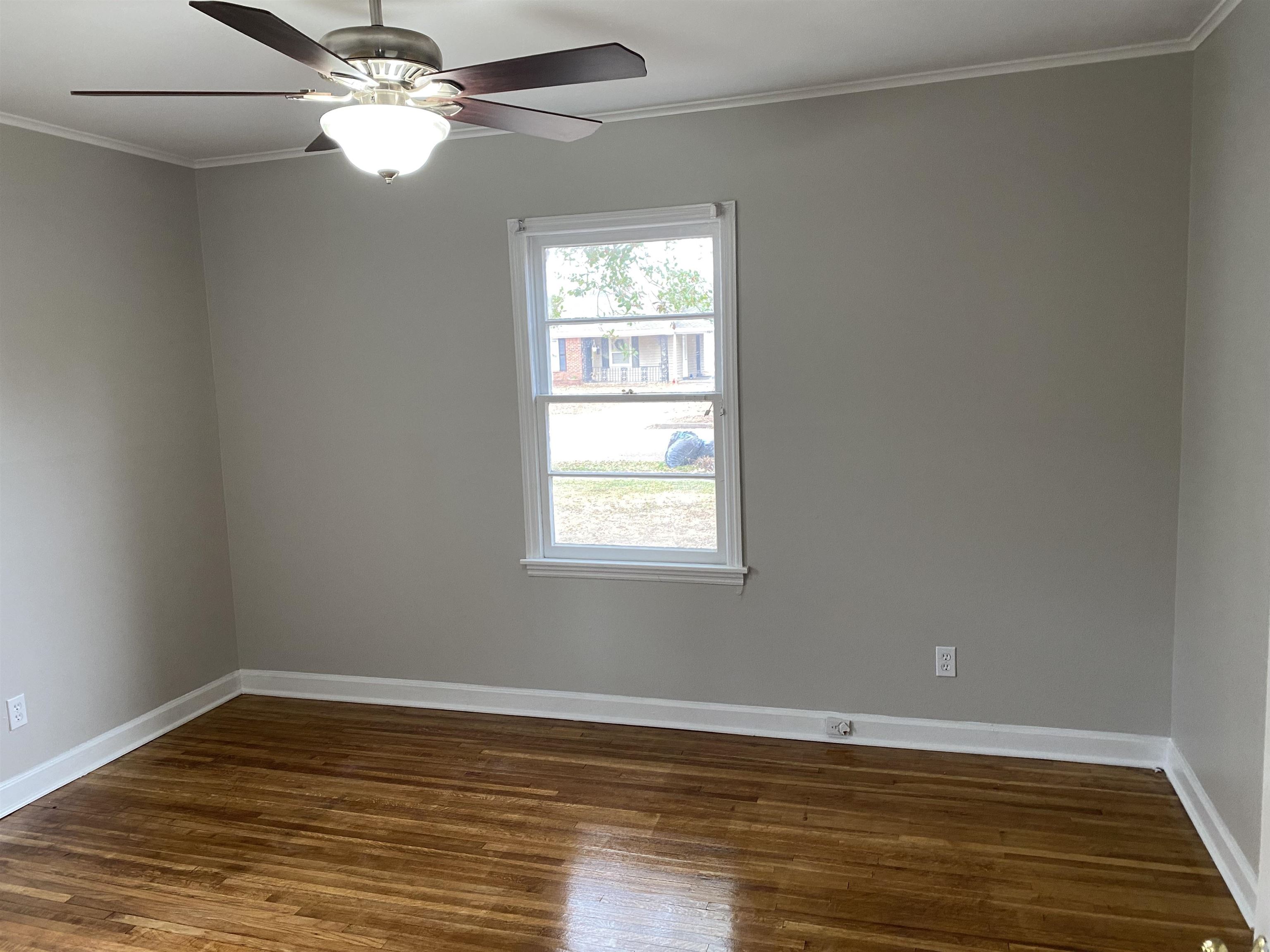 4621 Boyce Road Memphis, TN 38117 - Photo 18 of 25 a view of empty room with wooden floor and fan