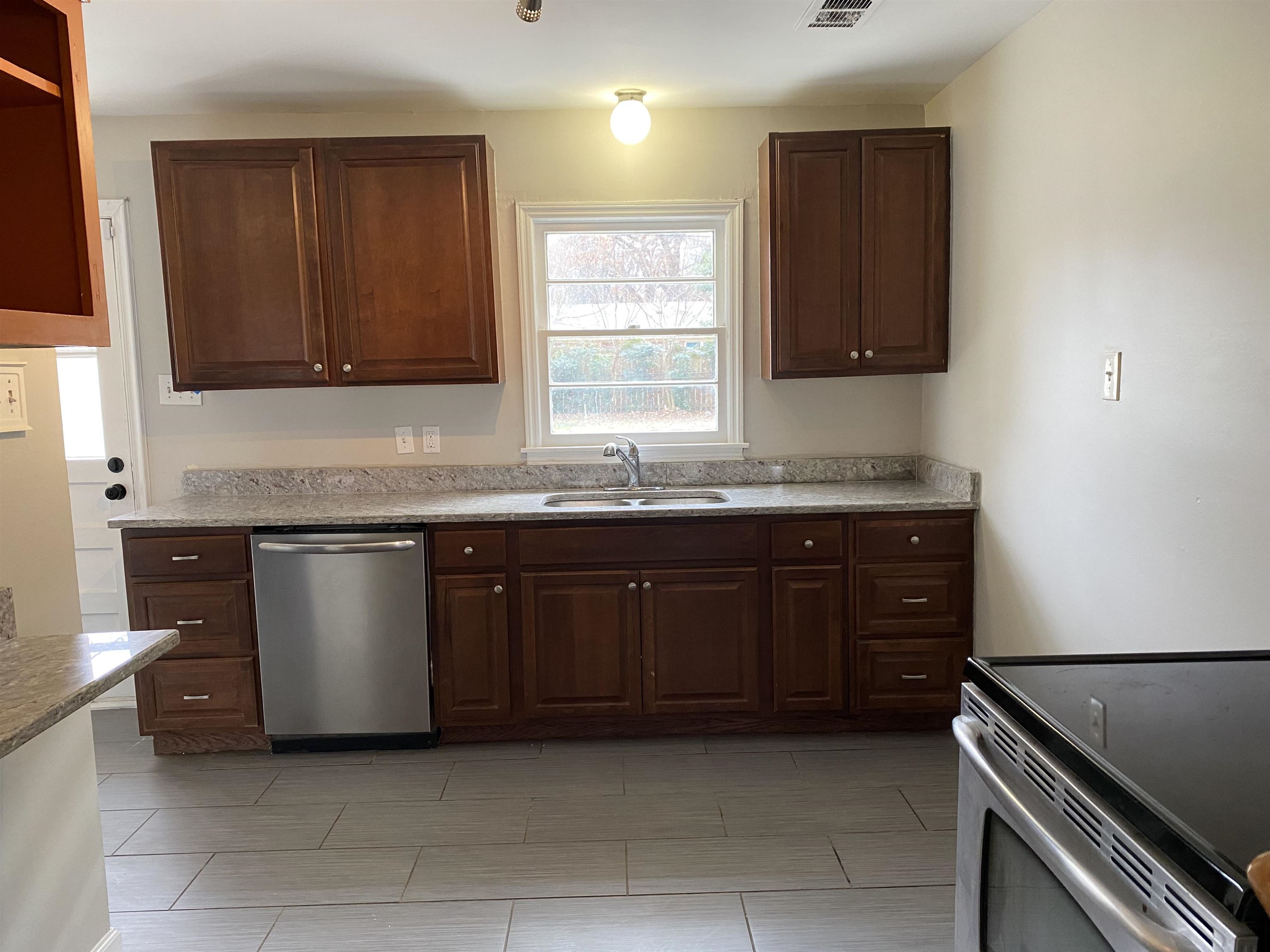 4621 Boyce Road Memphis, TN 38117 - Photo 7 of 25 a kitchen with granite countertop a sink and cabinets