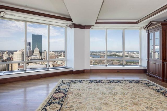 a view of a living room and chandelier fan