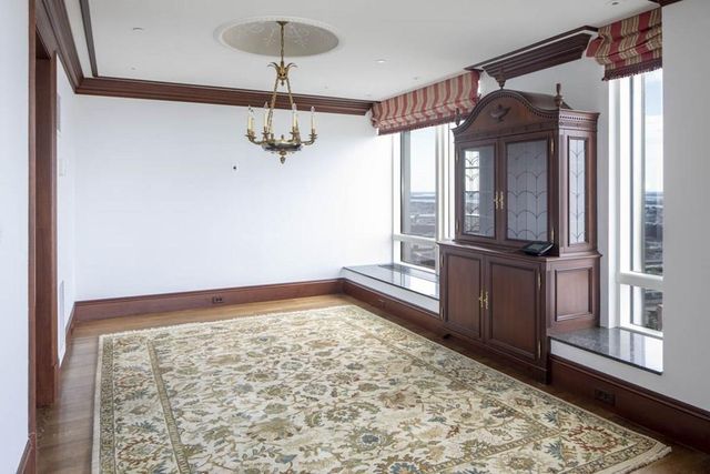 a view of a room with wooden floor and windows