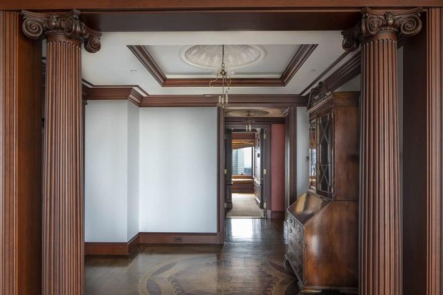 a view of a hallway with a furniture and staircase