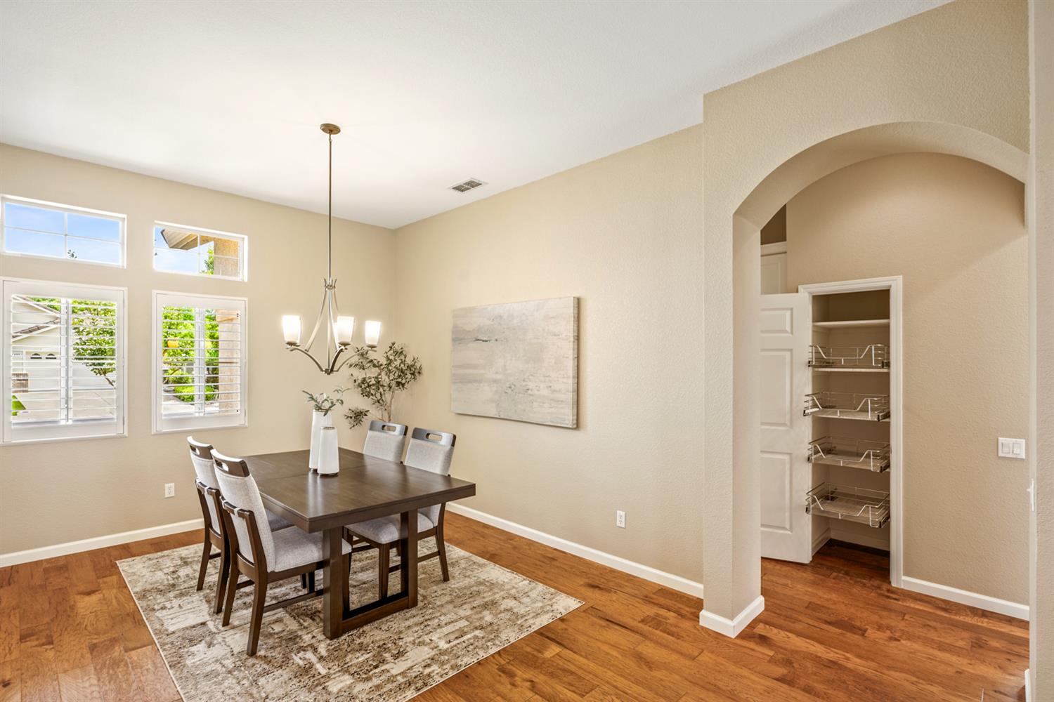 4081 Rose Creek Road Roseville, CA 95747 - Photo 6 of 52 a view of a dining room with furniture and wooden floor