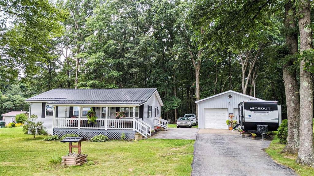 2646 Ridge Road Westover, PA 16692 - Photo 22 of 23 a front view of a house with a yard table and chairs