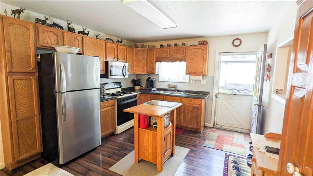 2646 Ridge Road Westover, PA 16692 - Photo 4 of 23 a kitchen with stainless steel appliances granite countertop a refrigerator a stove and a sink with wooden floor