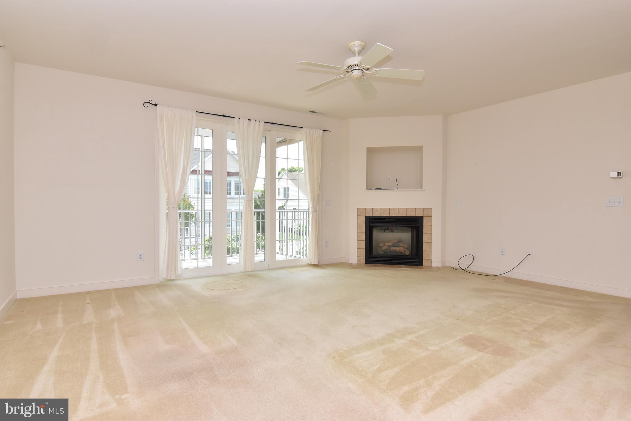 30619 Cedar Neck Road, Unit 1212 Ocean View, DE 19970 - Photo 4 of 57 Living room to screened-in porch