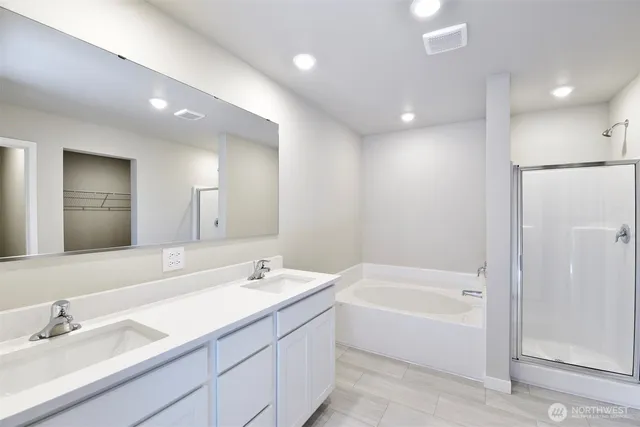 a bathroom with a bathtub a sink and a mirror