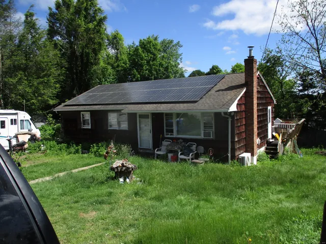 a view of house with backyard