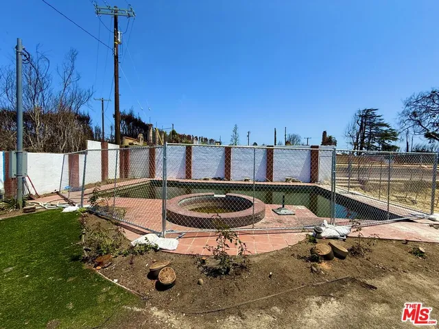 a view of a swimming pool with a yard