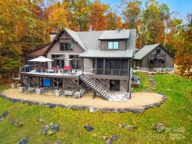 a view of a house with a yard patio and fire pit