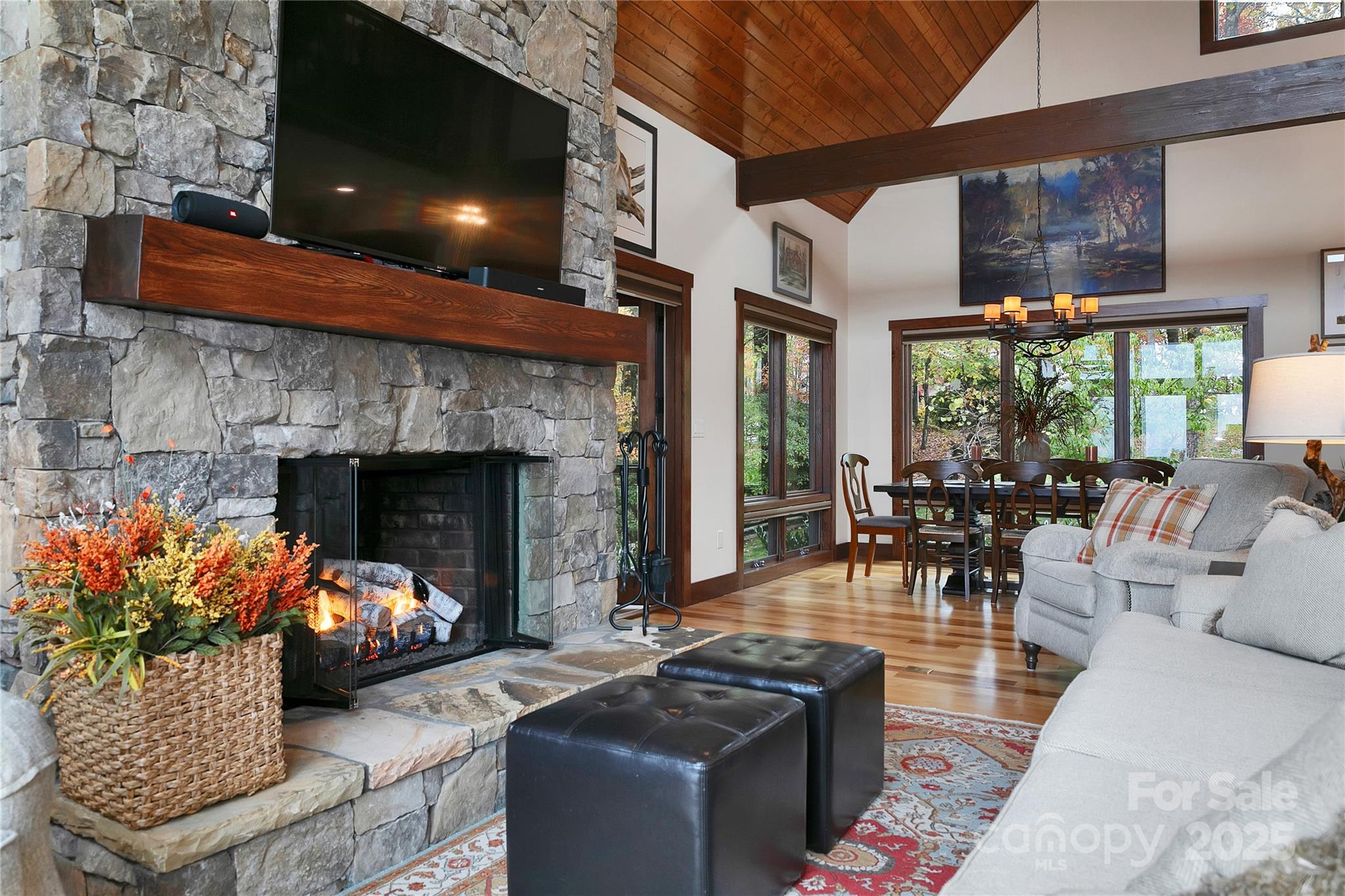 1291 Indian Camp Mountain Road Rosman, NC 28772 - Photo 11 of 48 a living room with furniture a fireplace and a floor to ceiling window