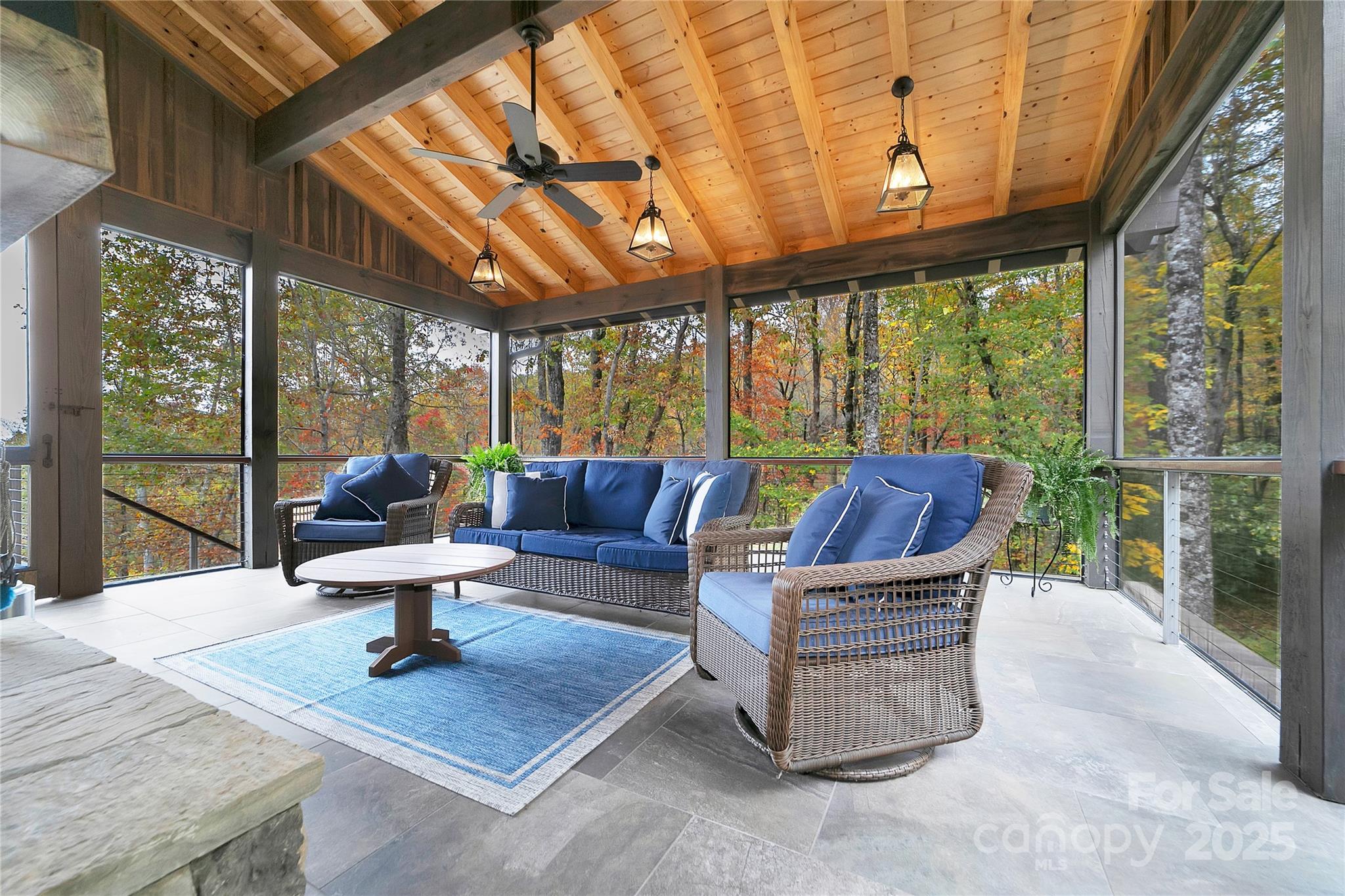 1291 Indian Camp Mountain Road Rosman, NC 28772 - Photo 15 of 48 a living room with furniture a large window and a table