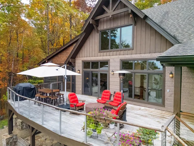 a view of deck with table and chairs under an umbrella with wooden floor