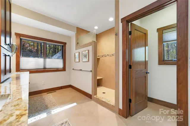 a spacious bathroom with double vanity and a large mirror