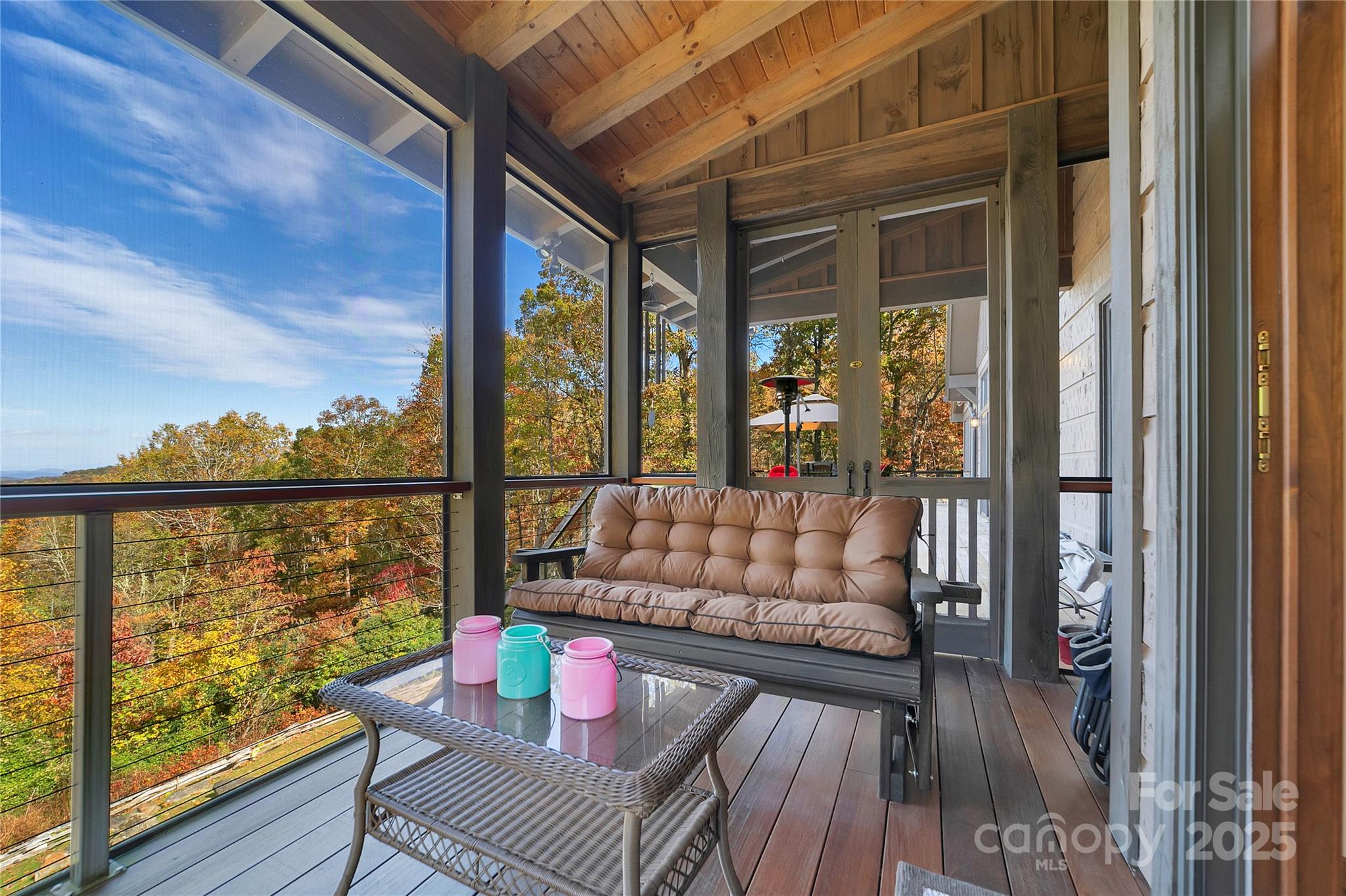 1291 Indian Camp Mountain Road Rosman, NC 28772 - Photo 25 of 48 a living room with large windows and wooden floor