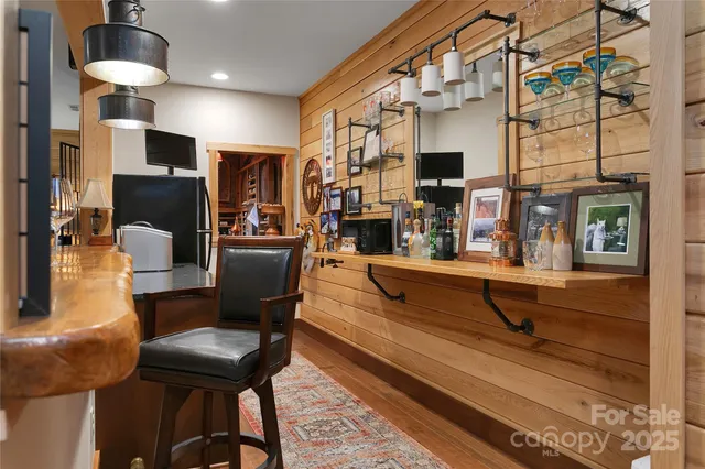 a dining hall with stainless steel appliances kitchen island granite countertop a refrigerator and a stove