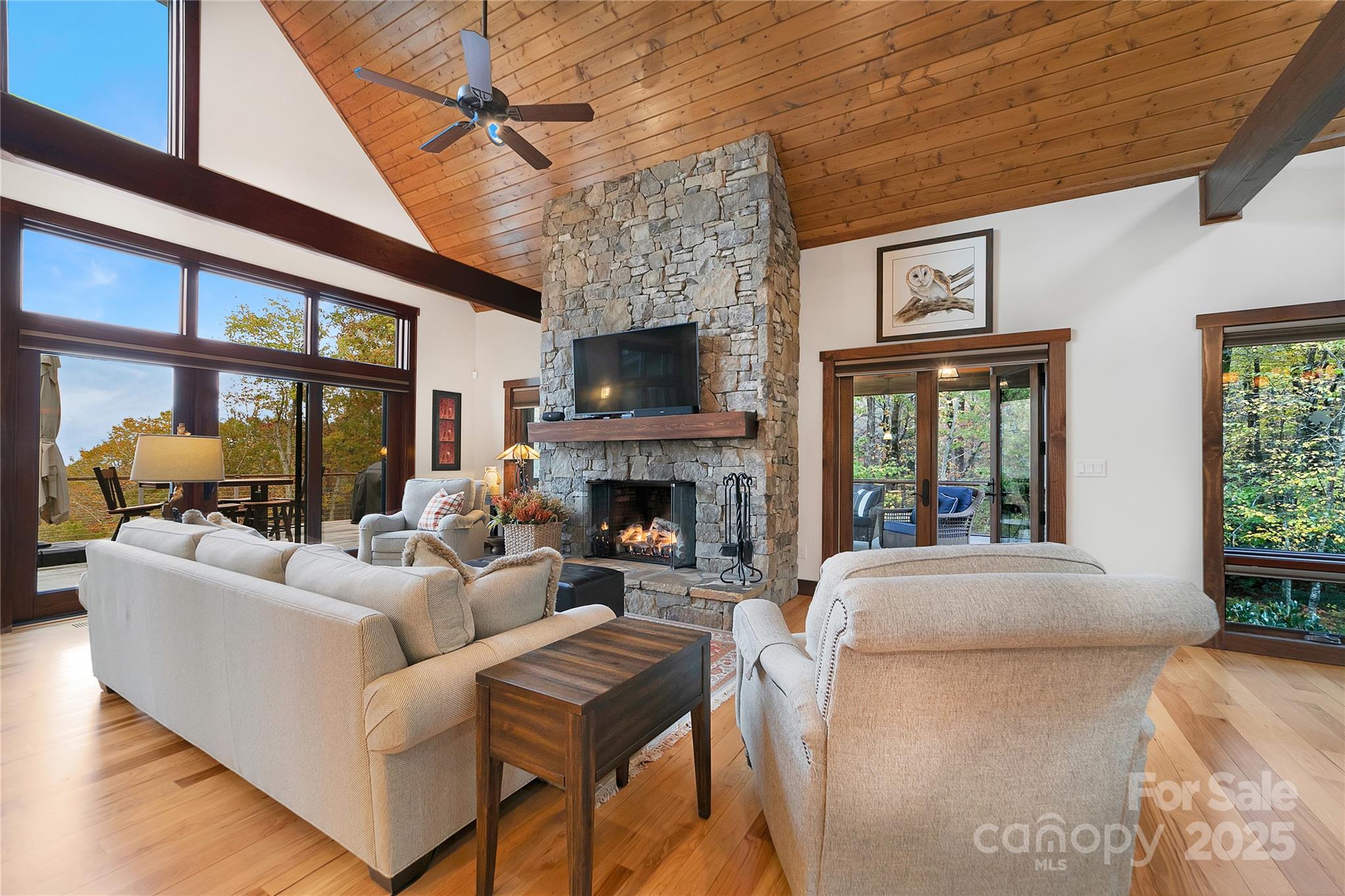 1291 Indian Camp Mountain Road Rosman, NC 28772 - Photo 10 of 48 a living room with furniture large window and a fireplace