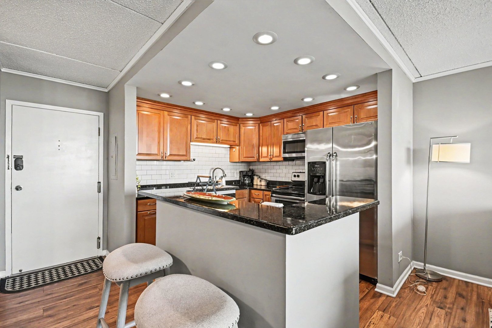 2015 South Finley Road, Unit 1107 Lombard, IL 60148 - Photo 6 of 22 a kitchen with stainless steel appliances granite countertop a sink refrigerator and cabinets