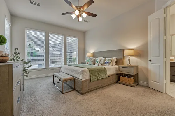 a bedroom with a bed chandelier and dresser