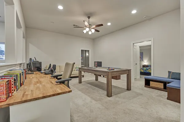 a living room with furniture a dining table and a chandelier
