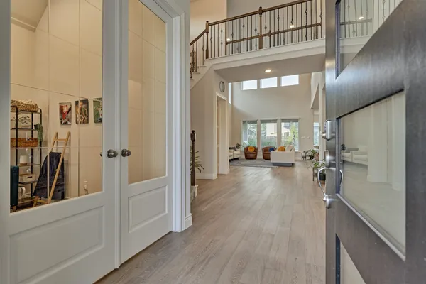 a view of a hallway view with living room and wooden floor