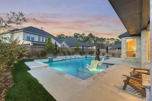 a view of a house with backyard porch and sitting area