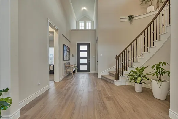 a view of an entryway with wooden floor and a potted plant
